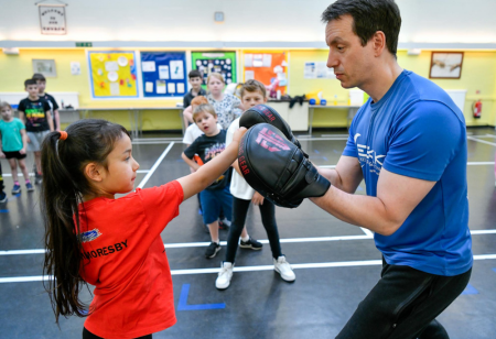 Girl being coached in martial arts
