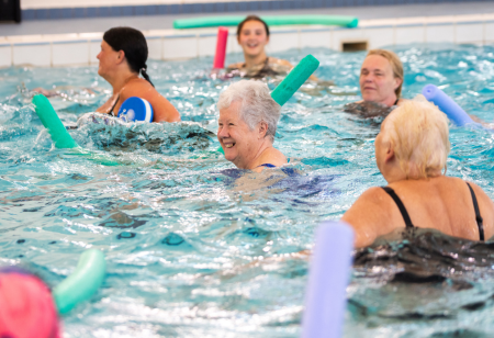 A group of older woman exercising in a swimming pool