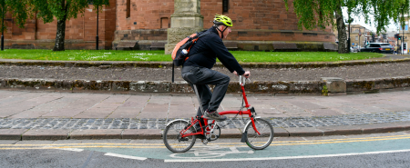 A man riding a bike on a road